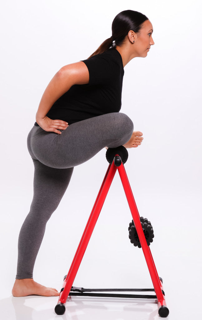 Side view of model performing hurdler stretch on anti gravity foam roller 