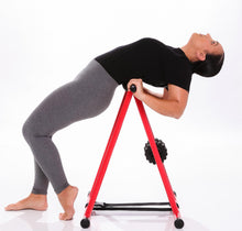 Load image into Gallery viewer, Model doing lower back release exercise on the anti gravity foam roller
